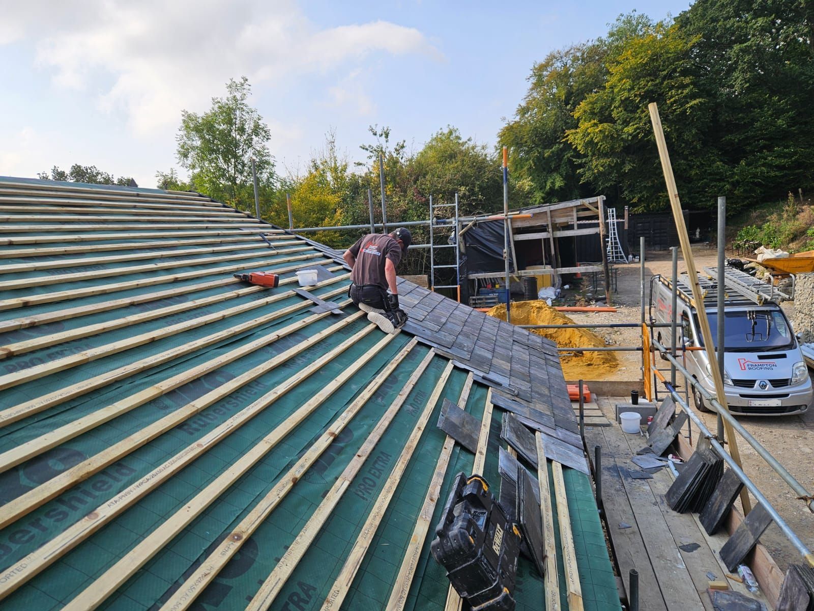 Roofer fitting Welsh slate on a property in Barham near Canterbury