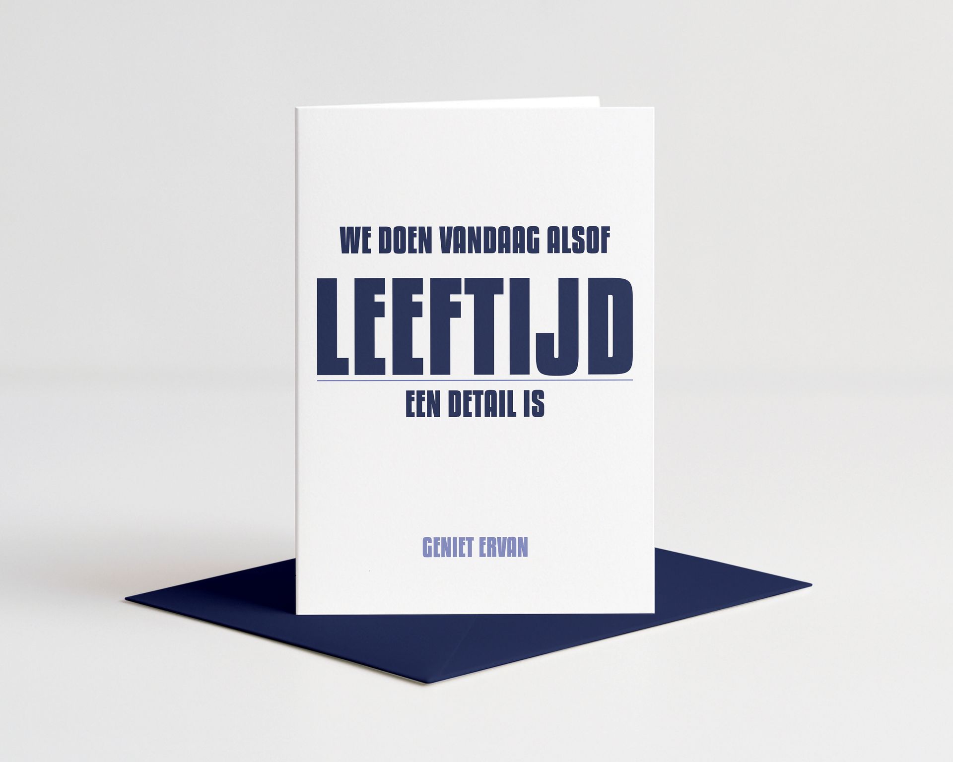 Card with blue text on a wooden block. Text reads