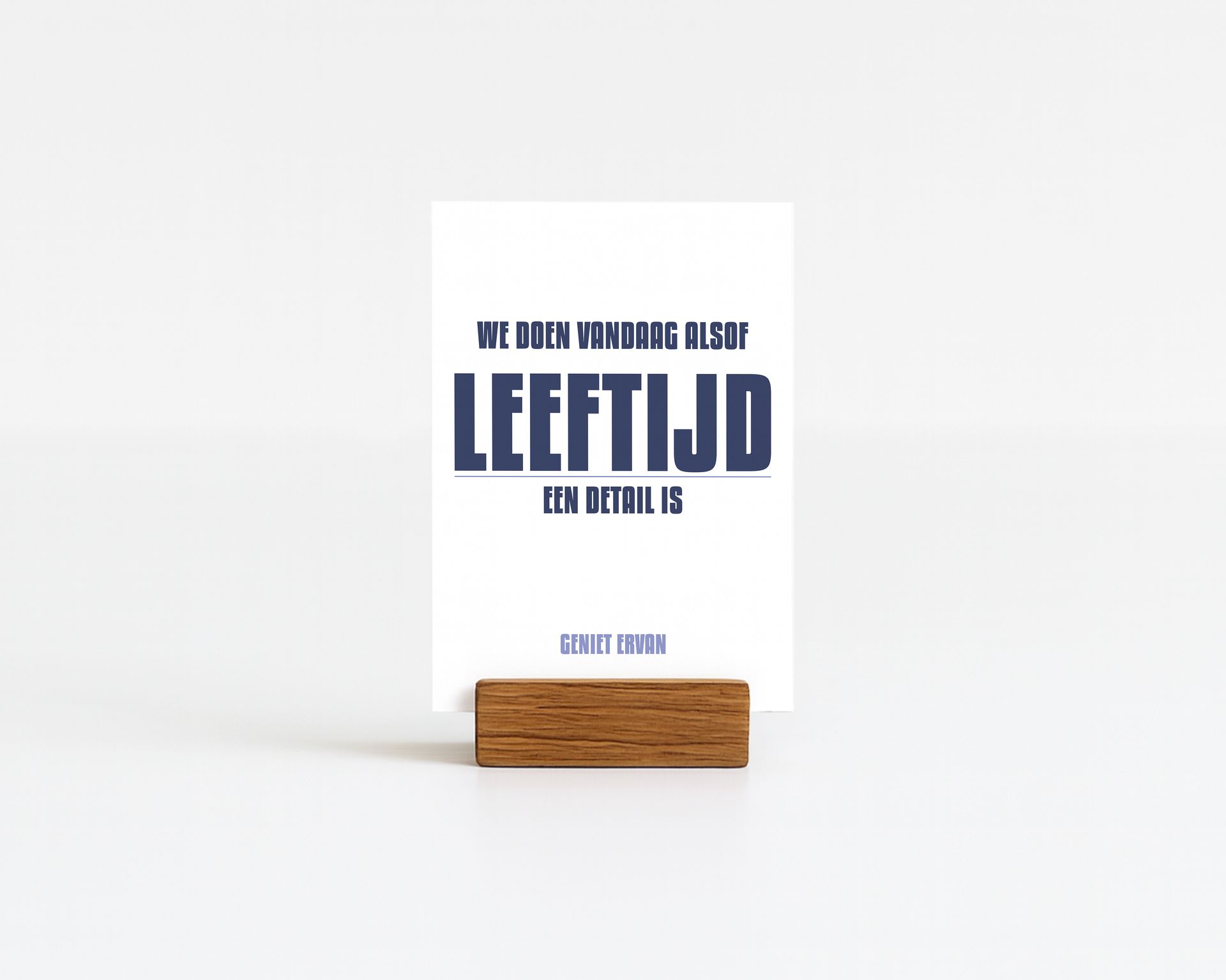 Card with blue text on a wooden block. Text reads
