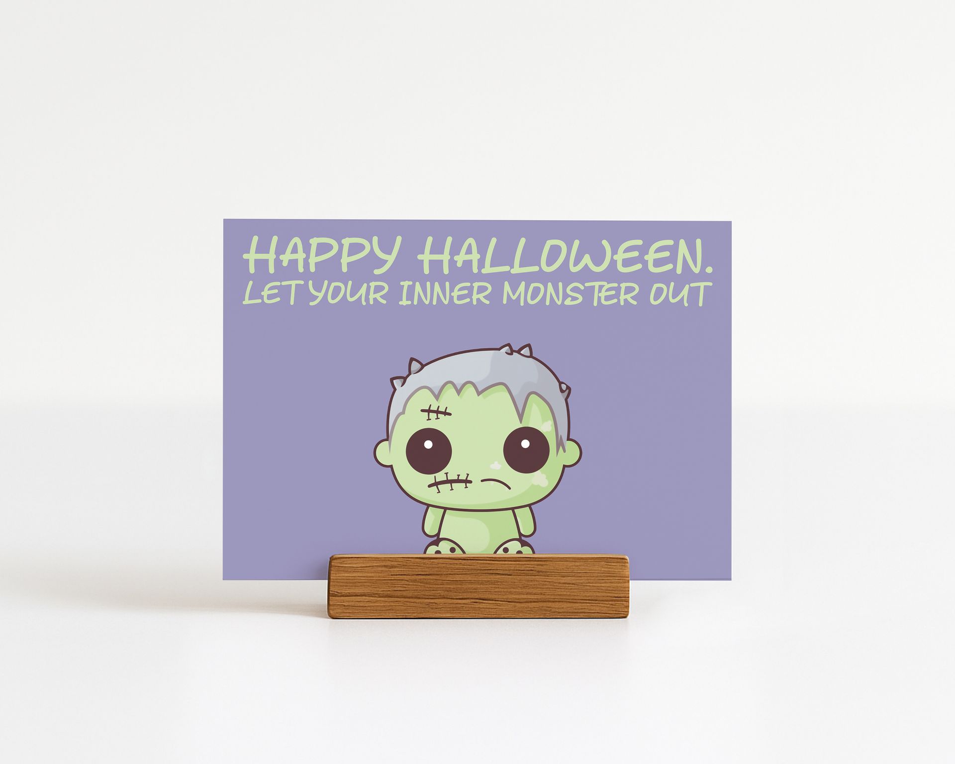 Halloween greeting card with cartoon Frankenstein, text "Happy Halloween. Let your inner monster out!"