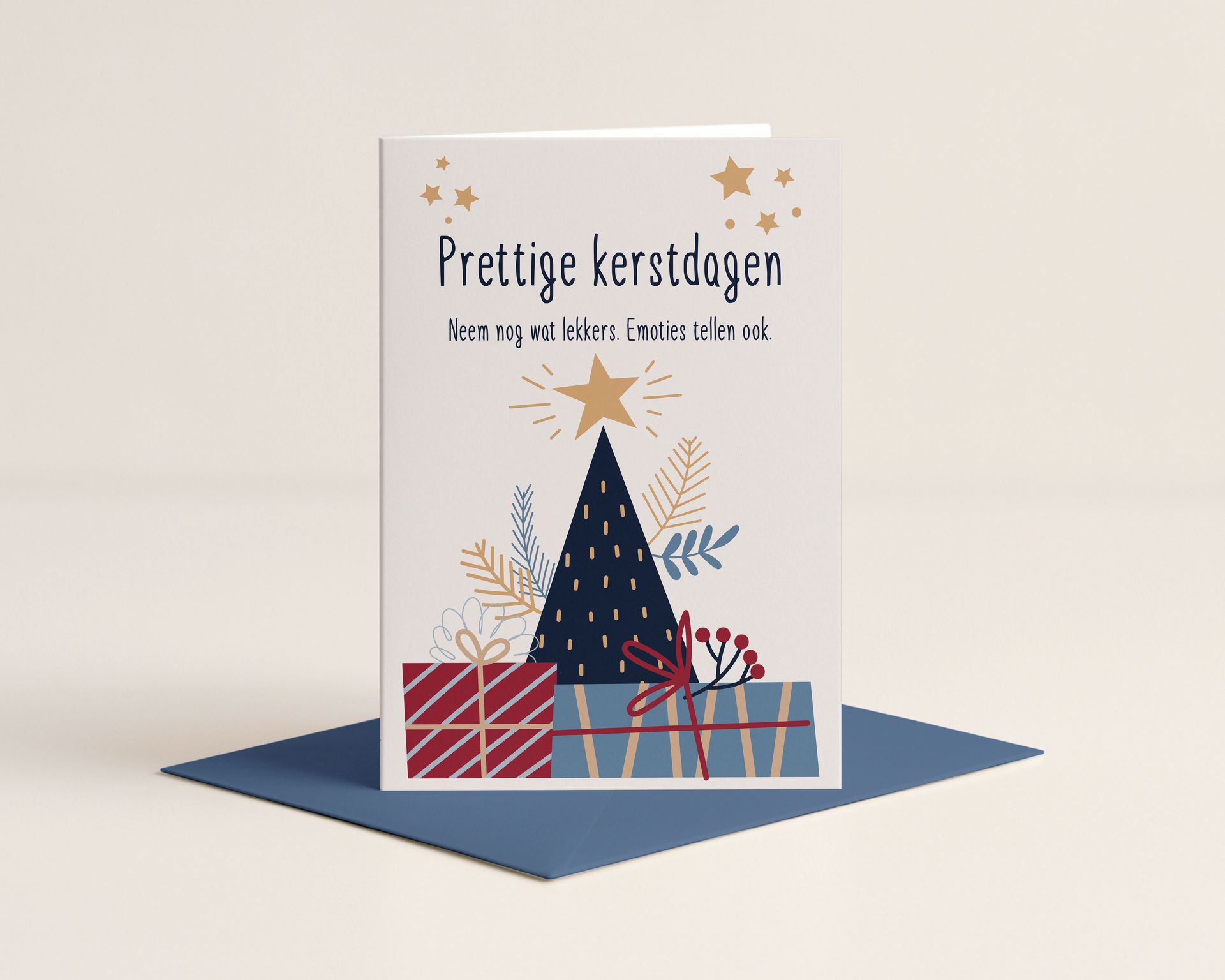 Christmas card with a tree, gifts, and text on a blue envelope.
