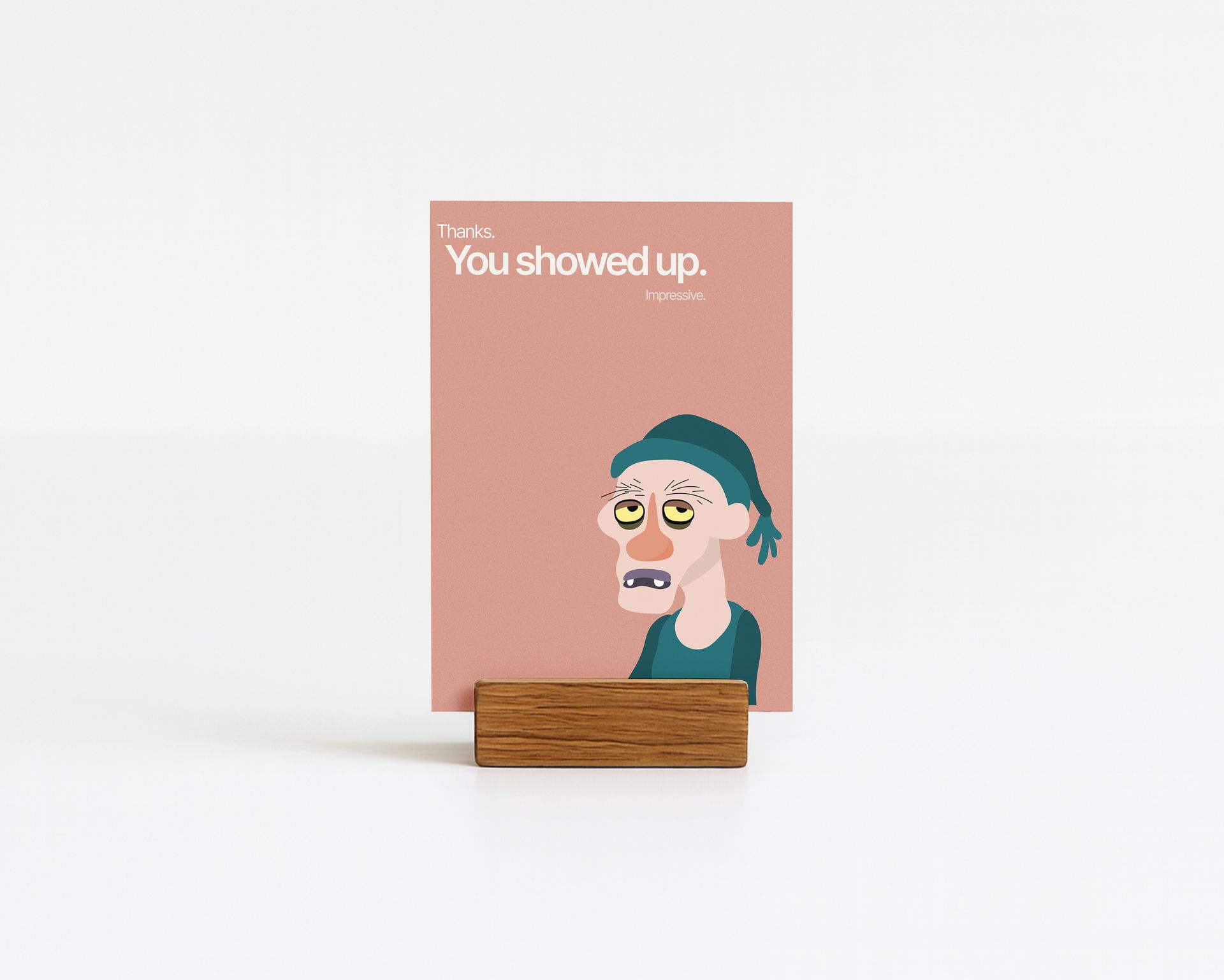 Card held in a wooden block, featuring an illustration of a tired face with text 