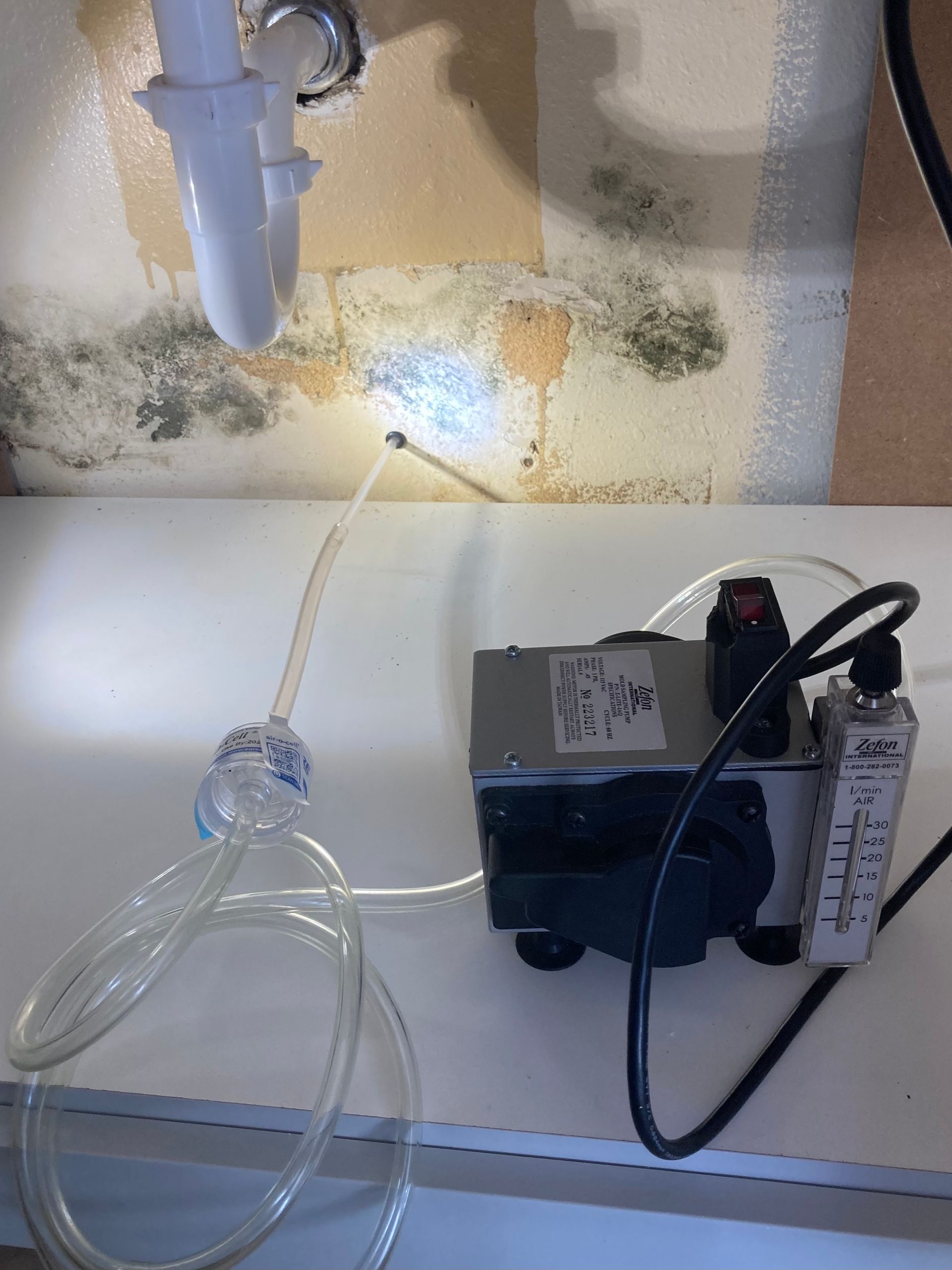 A machine is sitting on a counter next to a sink.