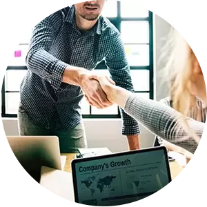 A man is shaking hands with a woman in an office.