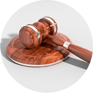 A wooden judge 's gavel is sitting on top of a wooden base.