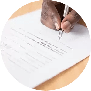 A person is signing a document with a fountain pen.