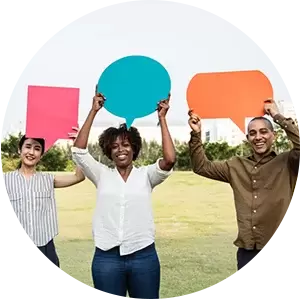 A group of people are holding up speech bubbles in a circle.