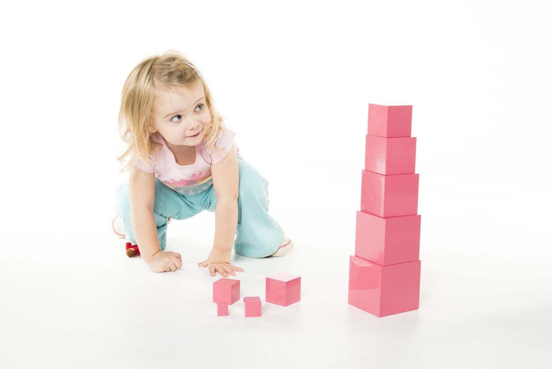 Montessori toddler working with the Montessori pink tower