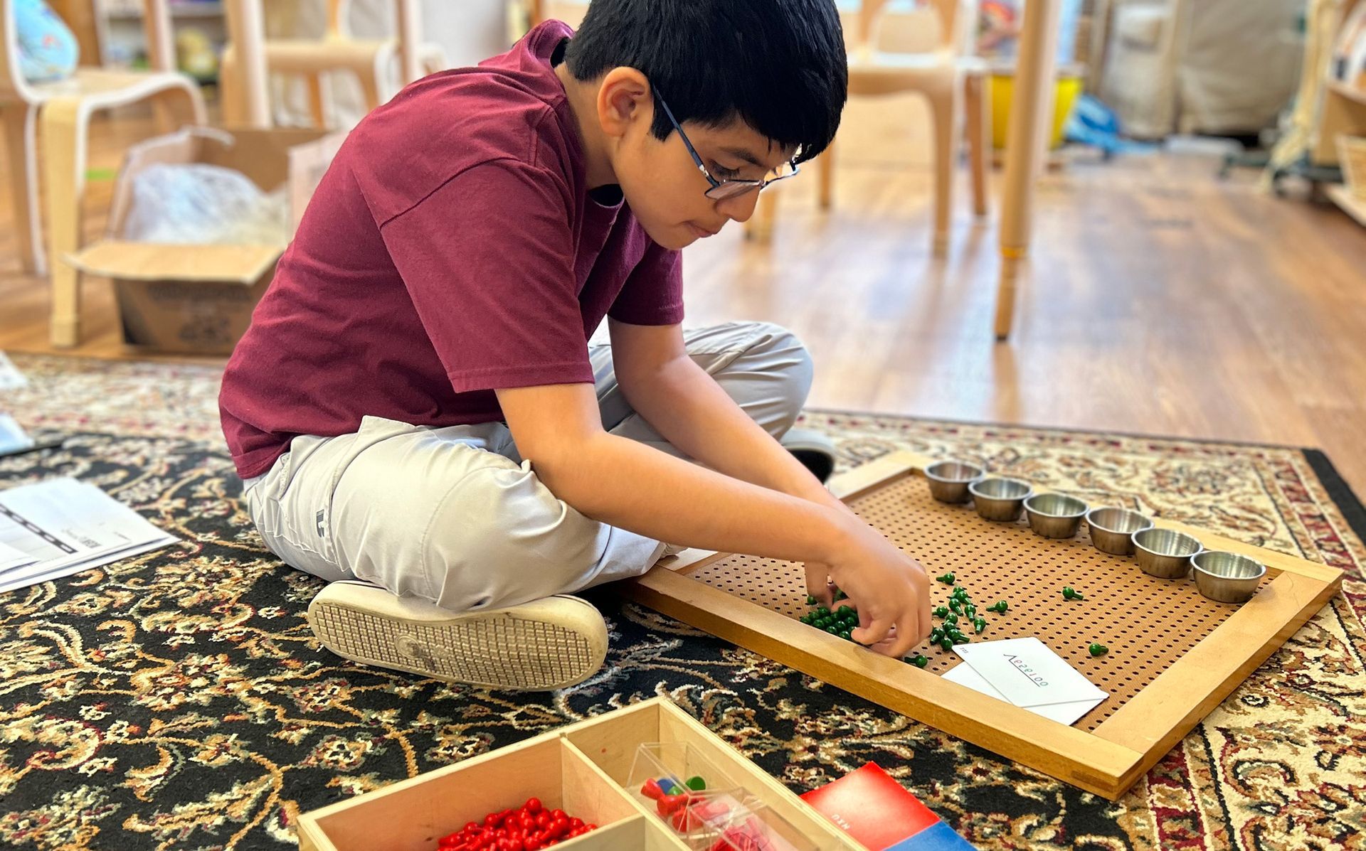 Montessori toddler working with the Montessori pink tower