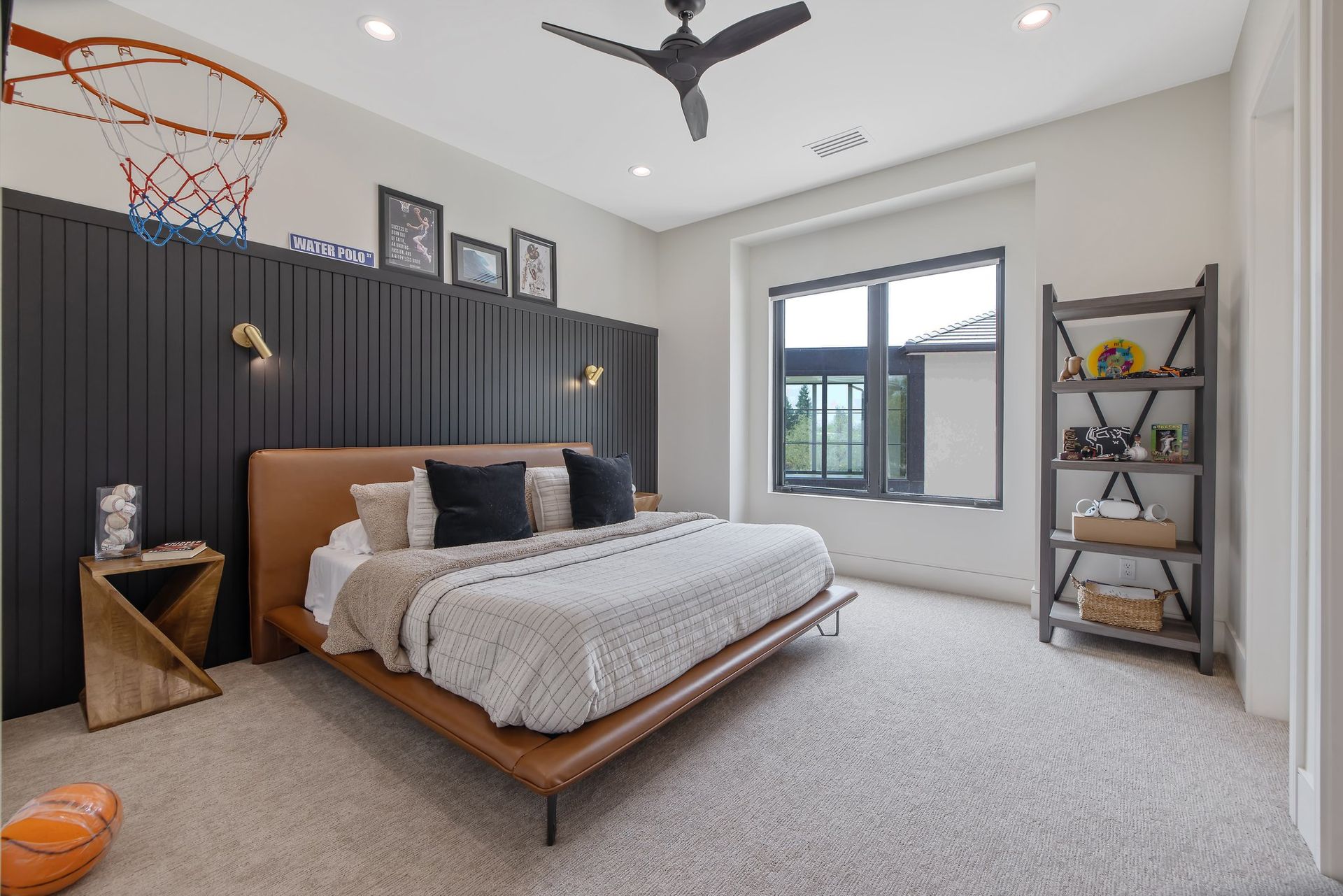 Modern bedroom with a bed, black slat wall, window, basketball hoop, and shelving unit
