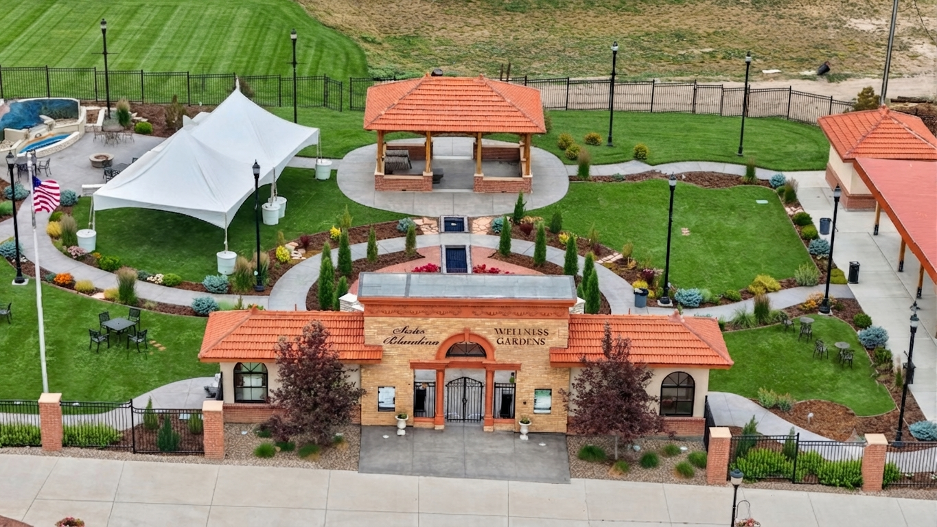 Aerial view of a landscaped park with tiled-roof pavilions, a central entrance, and winding paths.