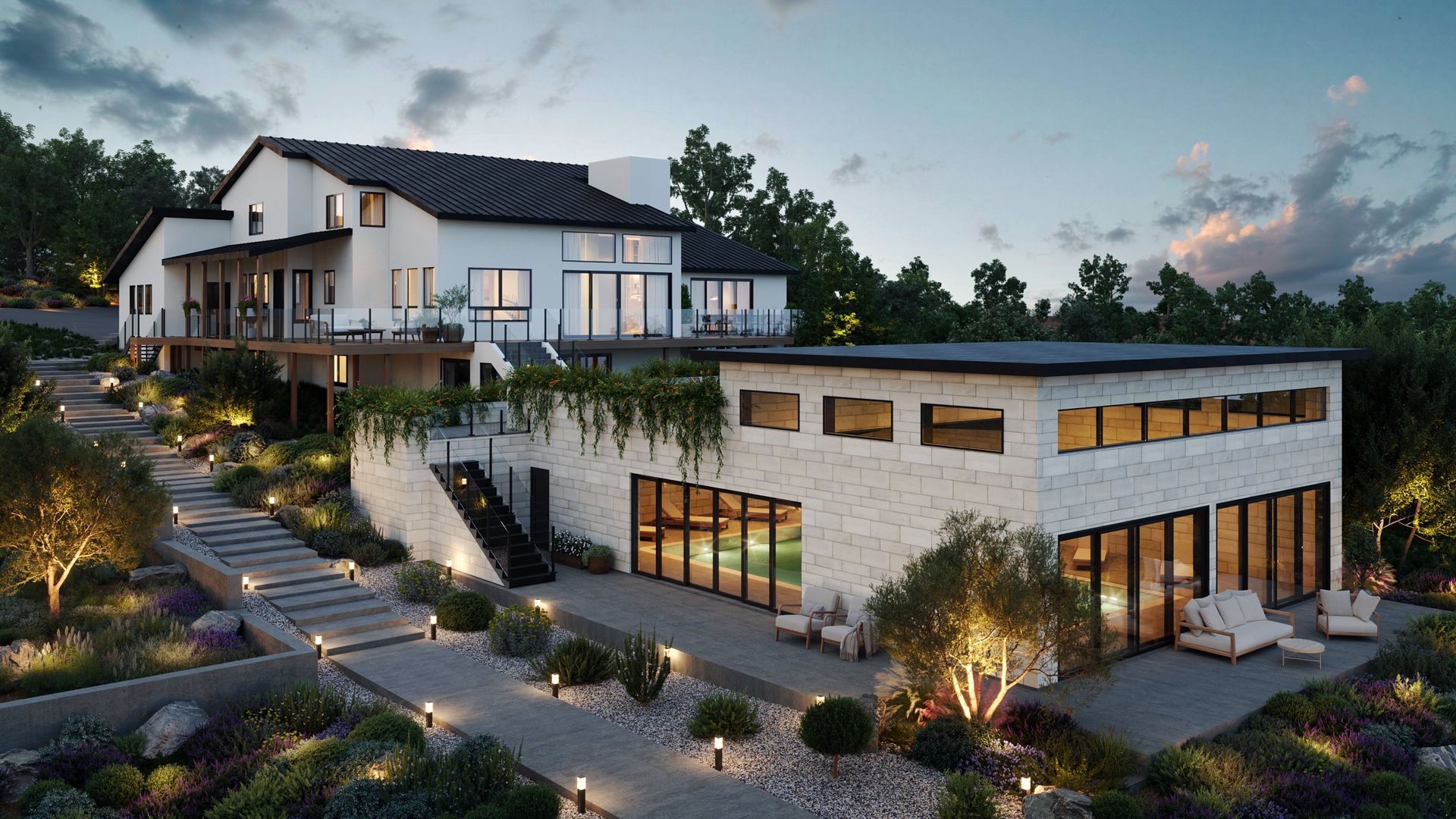 Modern hillside home with stone walls, large windows, and landscaped steps at dusk