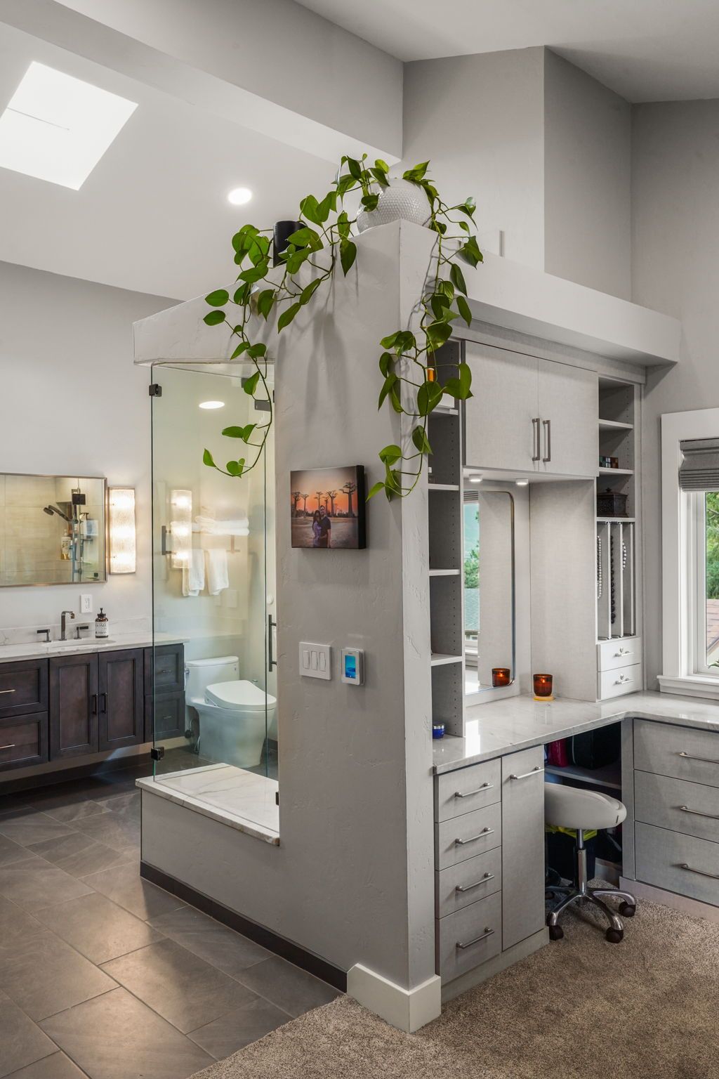 Bright modern home office nook with a built-in desk, drawers, and trailing green plant vines