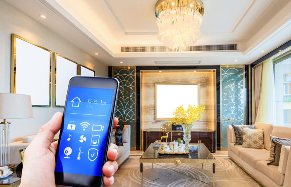 Hand holding a smartphone controlling smart home devices in a bright luxury living room