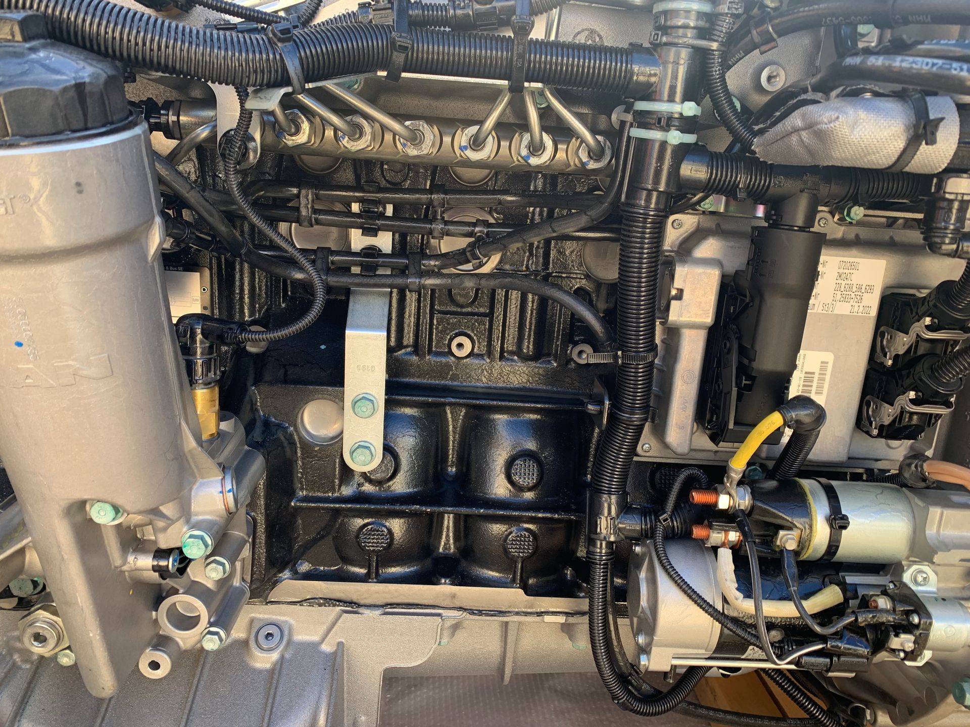 Close-up of a black and silver engine with various connected components.