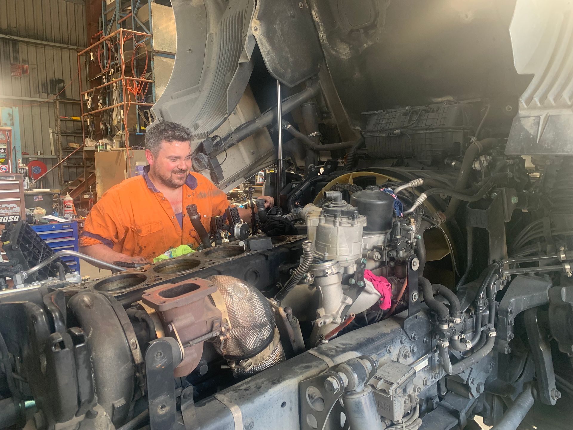 Professional bus mechanic working in vehicle repair service. Professional bus mechanic working in vehicle repair service.
