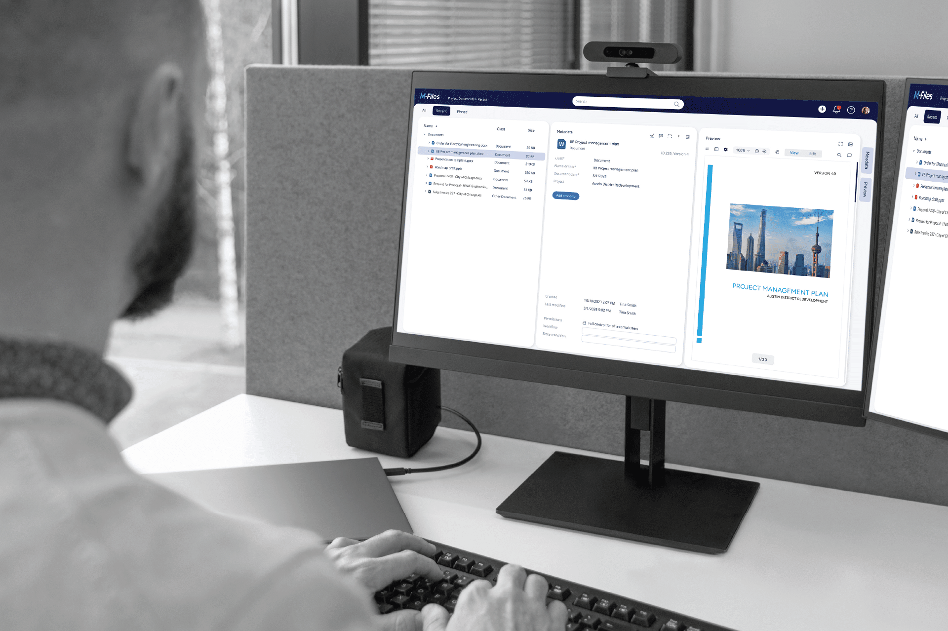 Guy doing document management on his monitor