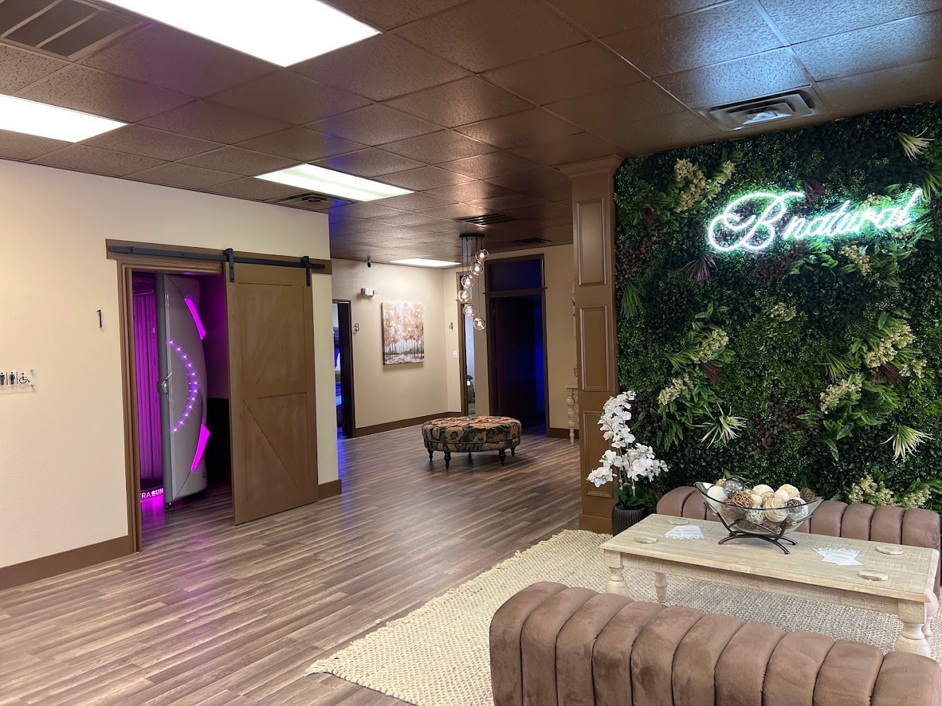 A living room with a couch , table and a green wall.