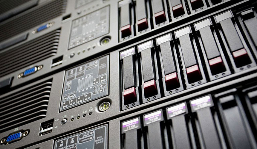 Close-up of black server racks with status lights and ventilation grilles in a data center