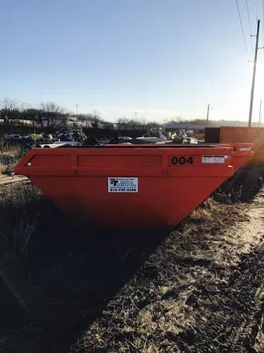 An orange dumpster labeled 