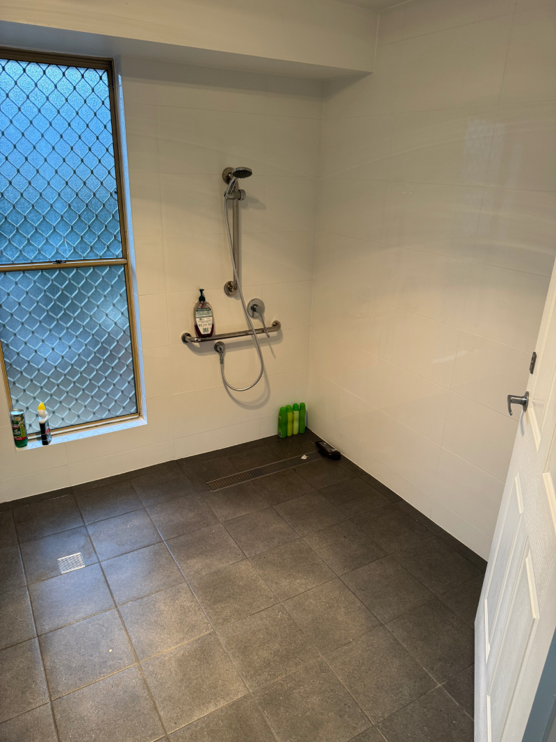 Home modifications. A bathroom with a shower and a window.