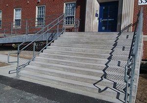 a set of stairs leading up to a building with a metal railing