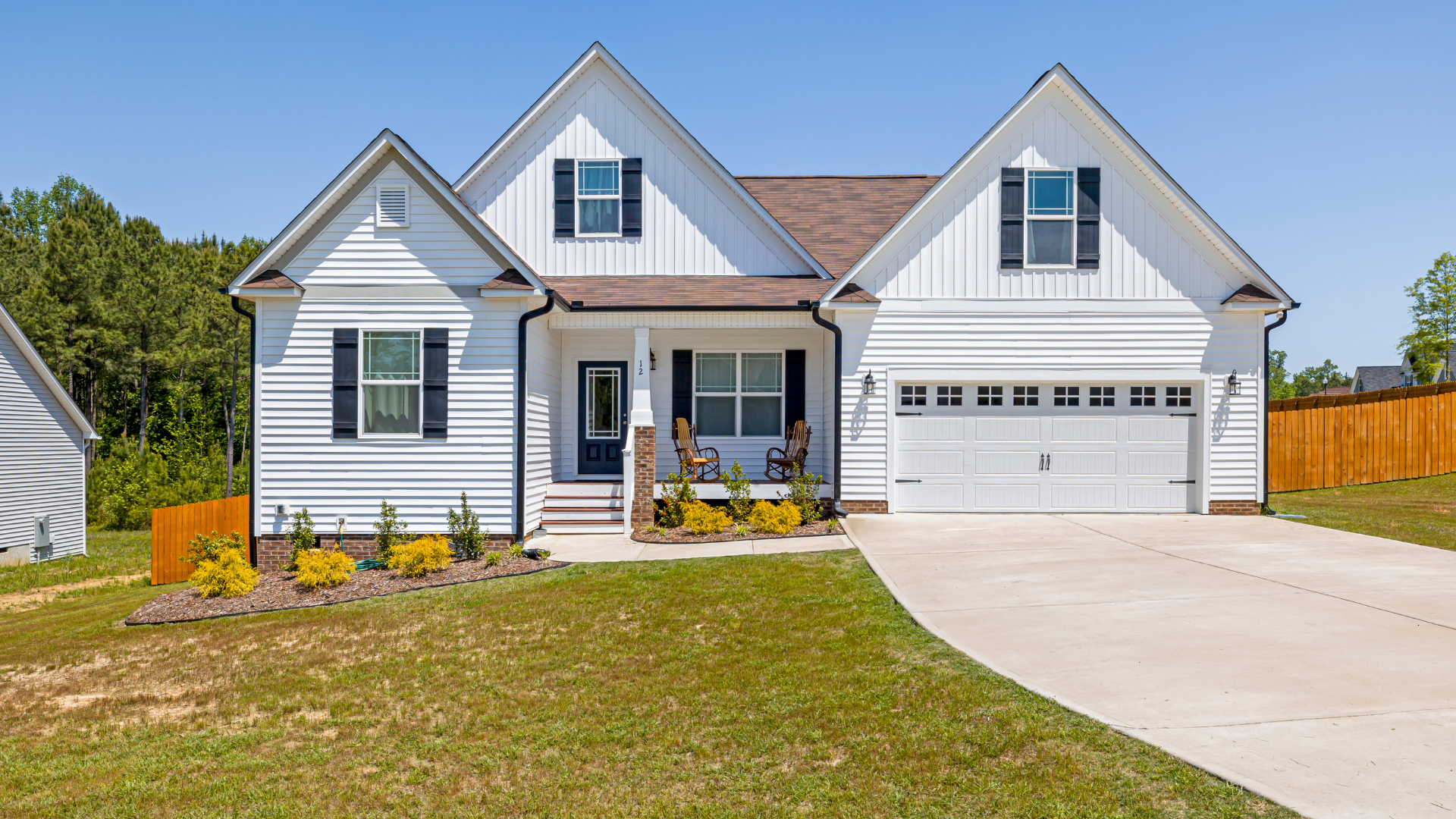 a large white house with a garage and a driveway