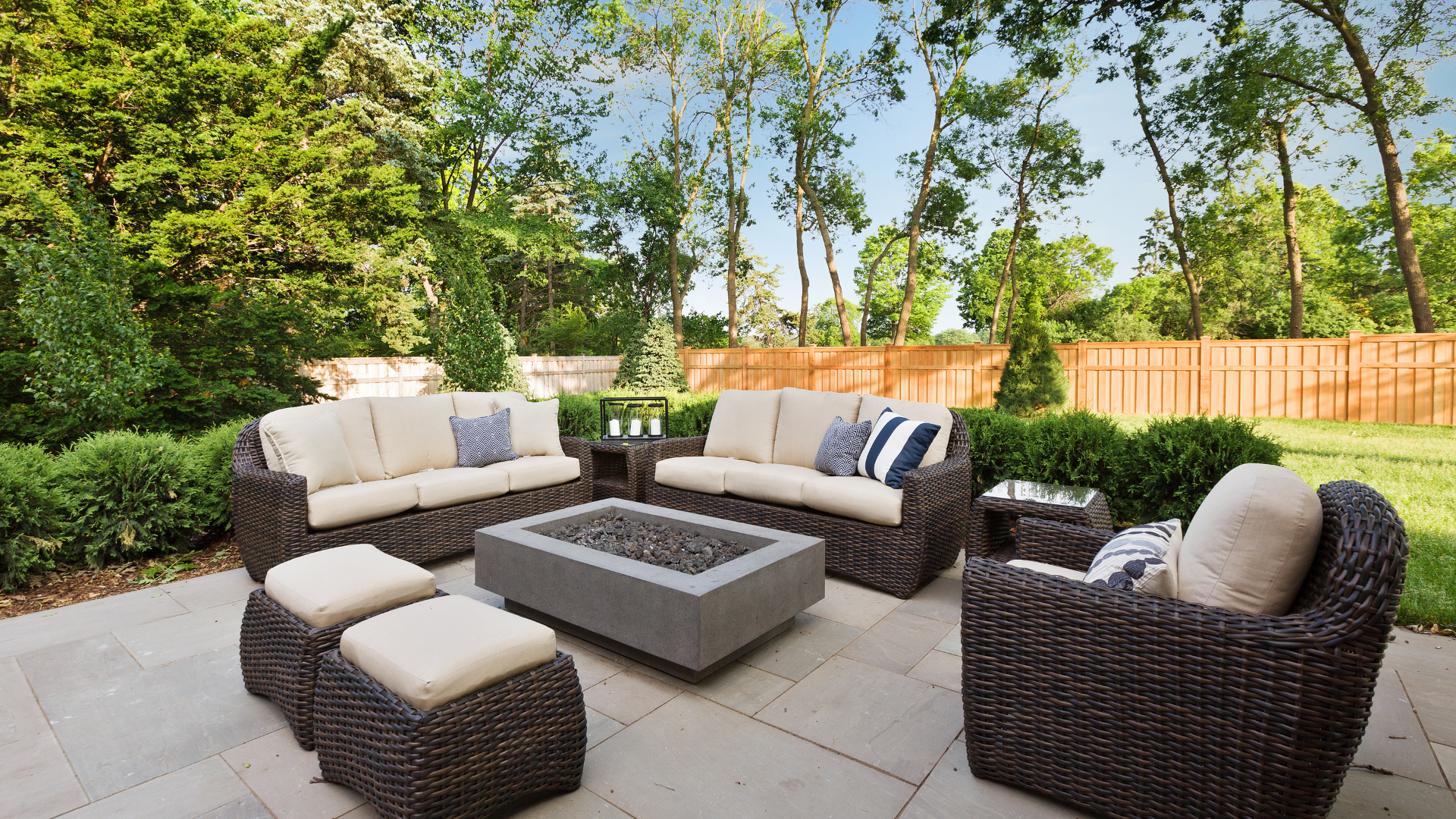 a patio with wicker furniture and a fire pit