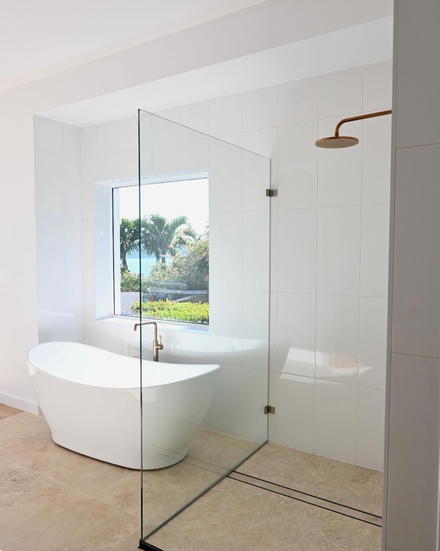 A Bathroom With a Bathtub and a Walk in Shower โ Coral Coast Building & Management in Cannon Valley, QLD
