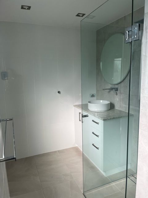 A Bathroom With a Sink and a Mirror in It — Coral Coast Building & Management in Cannon Valley, QLD