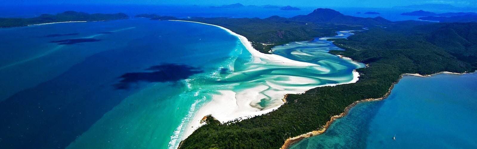 An Aerial View of a Small Island in the Middle of the Ocean — Coral Coast Building & Management in Cannon Valley, QLD