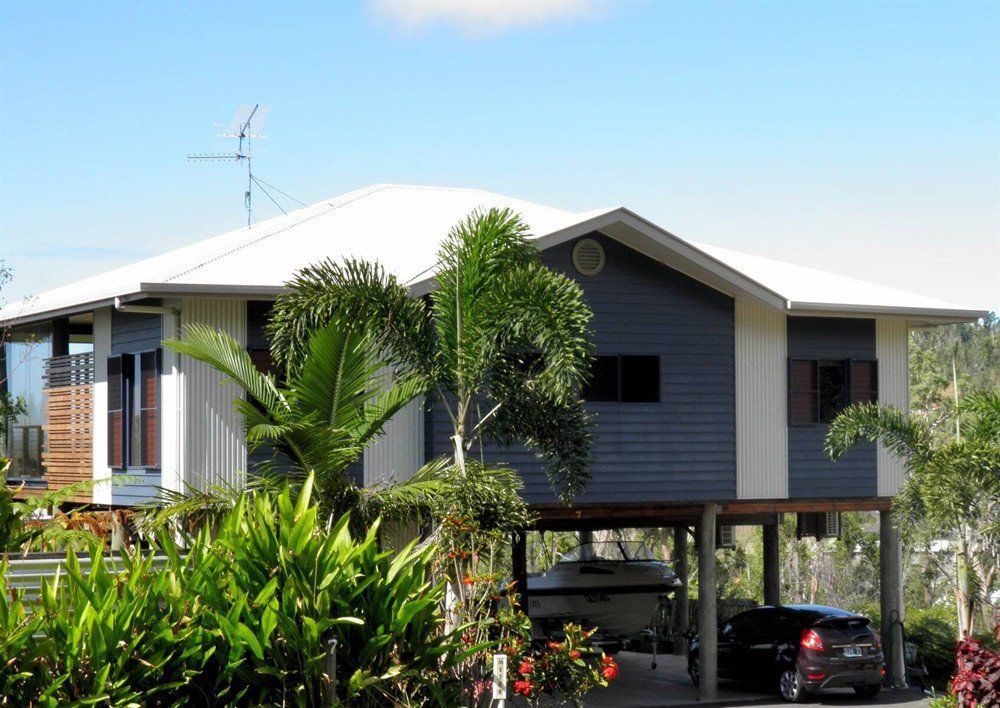 A House With a Car Parked in Front of It — Coral Coast Building & Management in Cannon Valley, QLD