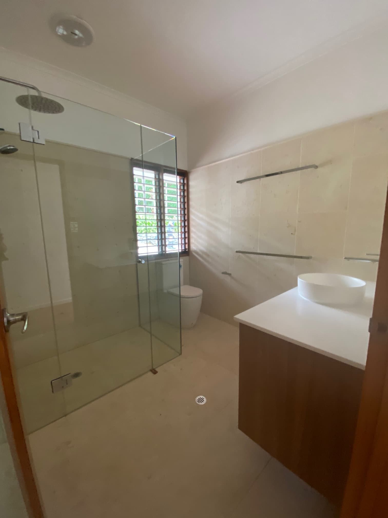 A Bathroom With a Toilet , Sink and Walk in Shower — Coral Coast Building & Management in Cannon Valley, QLD
