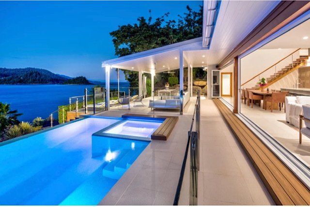 A Large House With a Swimming Pool and a View of the Ocean — Coral Coast Building & Management in Cannon Valley, QLD