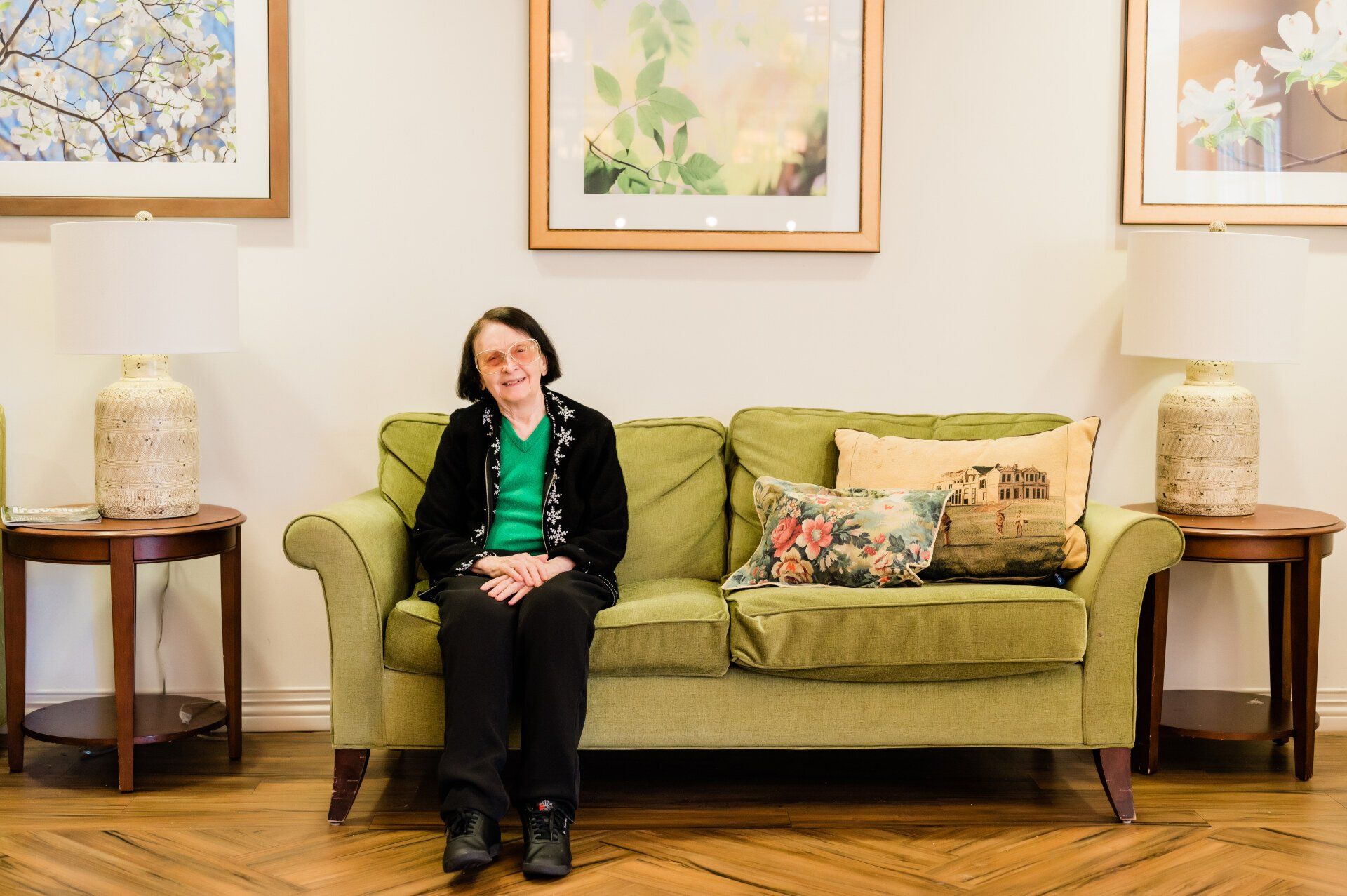 Jane Christensen sitting on green couch.