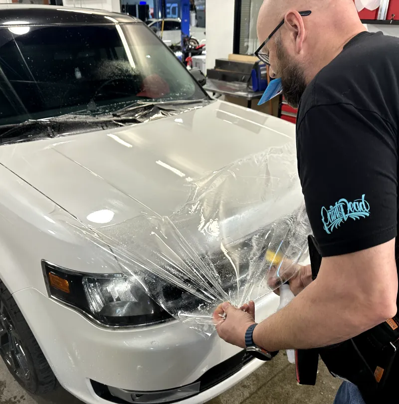 a man wearing a black shirt that says ' rv cleaning ' on it