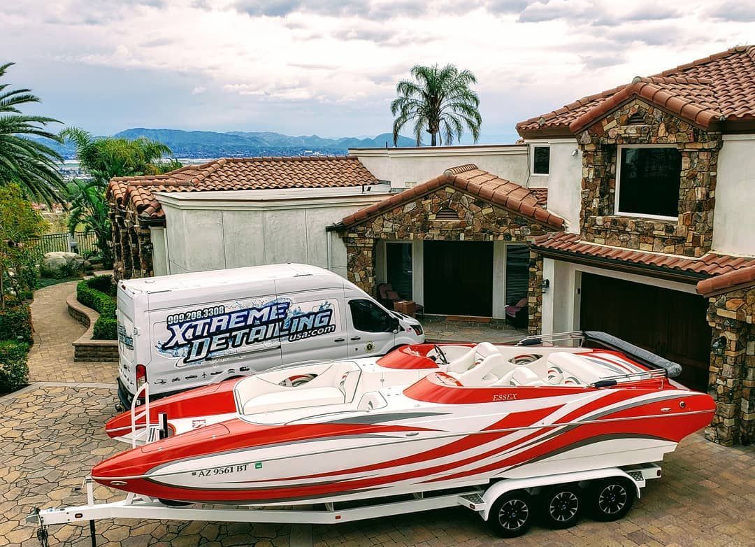 a white and pink buggy is parked in a garage next to a rv .