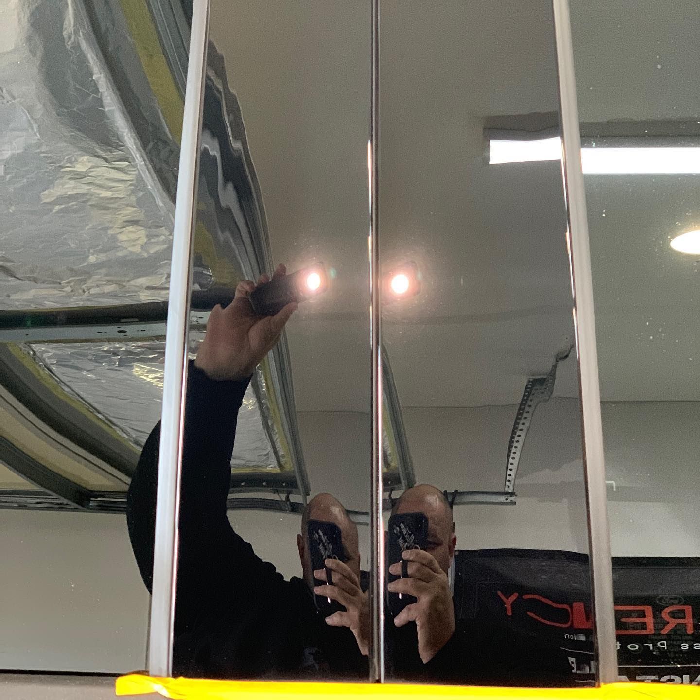 a person is taking a picture of their reflection in a mirror