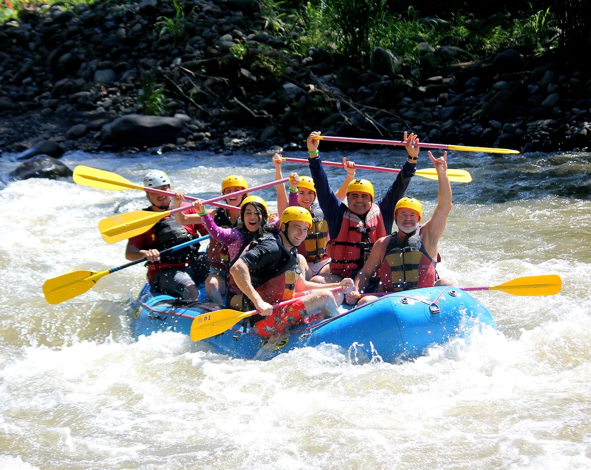 A group of people are riding a raft down a river.