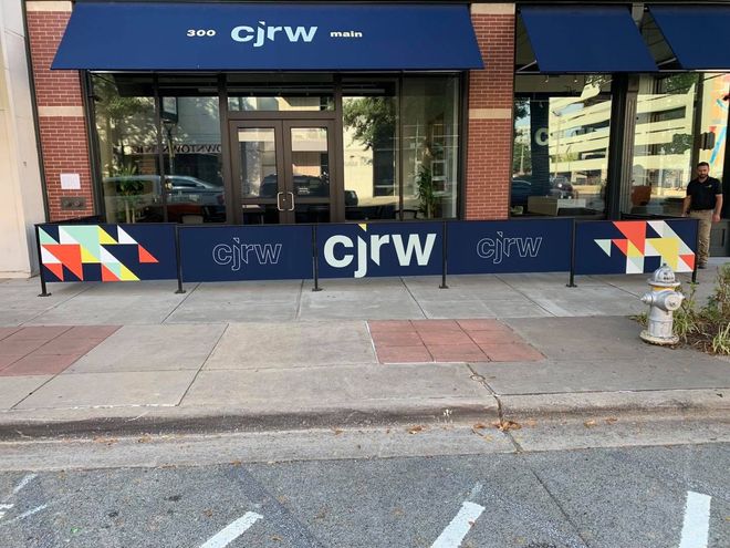 A store front with a blue awning and a sign that says cjrw