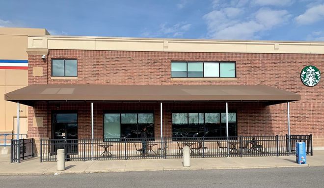 A brick building with a starbucks logo on it.