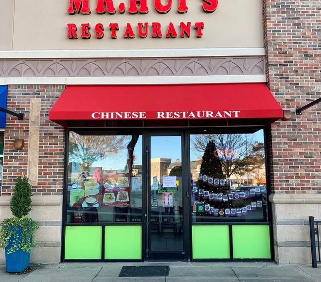 A chinese restaurant with a red awning over the door