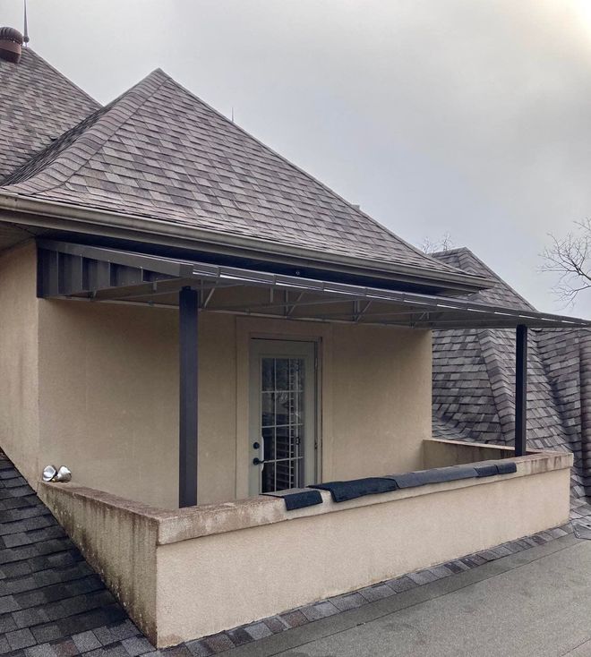 A small house with a porch and a roof
