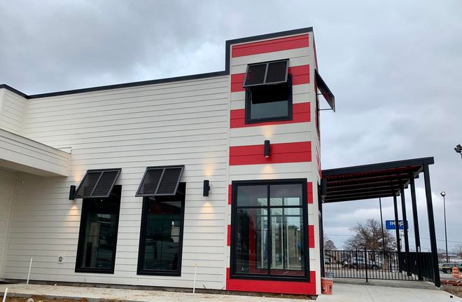 A red and white striped building with a lot of windows.