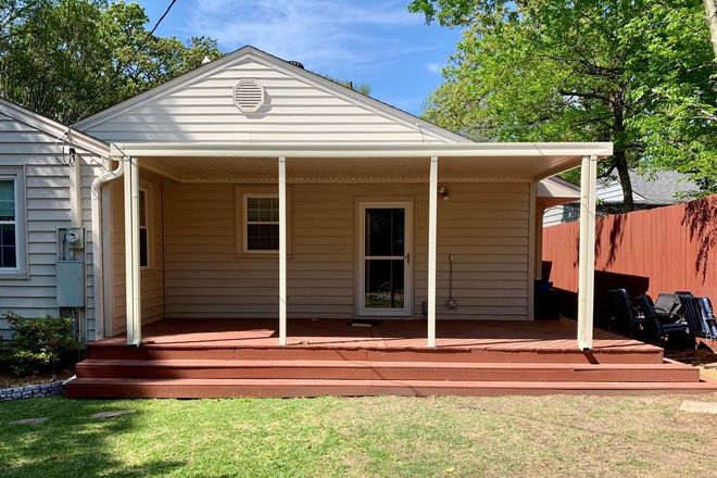 The back of a house with a porch and stairs.
