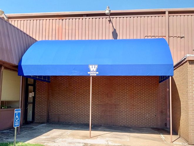 A blue awning with the letter w on it
