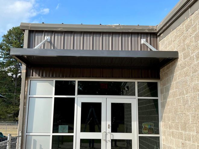 The front of a building with a canopy over the door