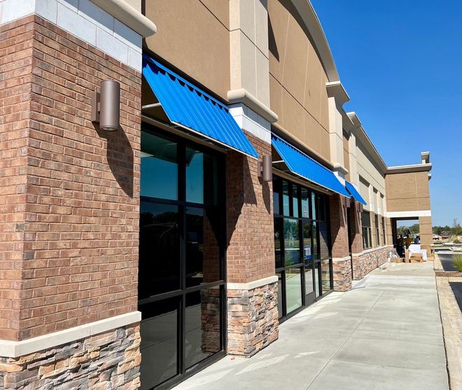 A building with a blue awning on the side of it