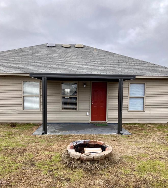 A house with a fire pit in front of it