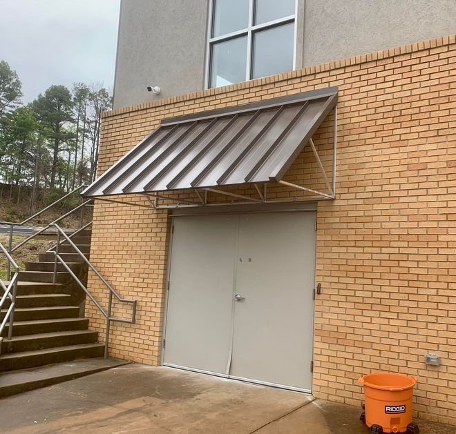 A brick building with a canopy over a door